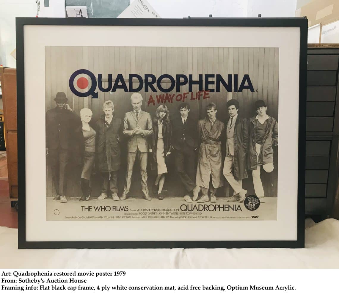 Framed Quadrophenia poster featuring a black-and-white photo of The Who band members with the title 'Quadrophenia' above them on a light background with a white mat and dark frame.